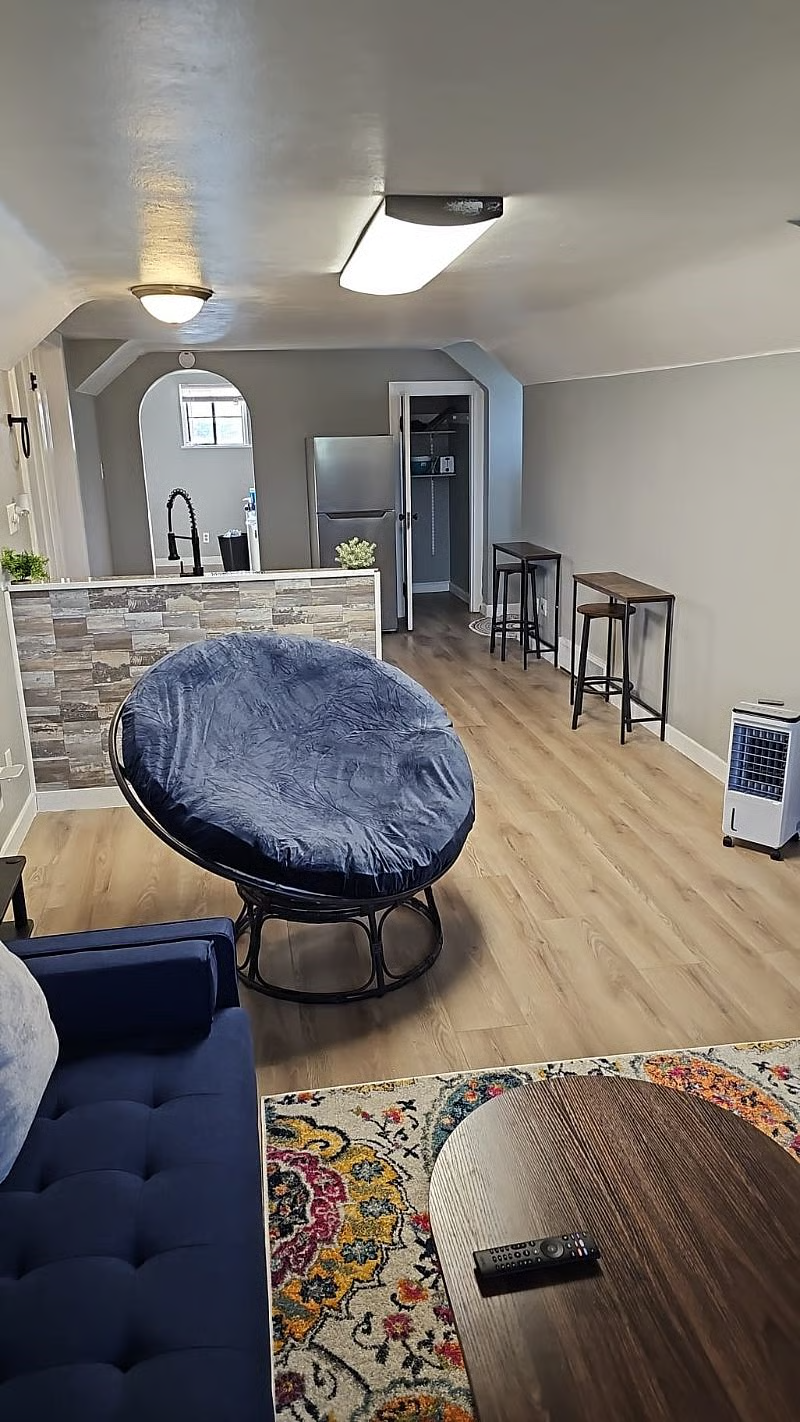 Top floor unit living area with papasan chair and kitchenette