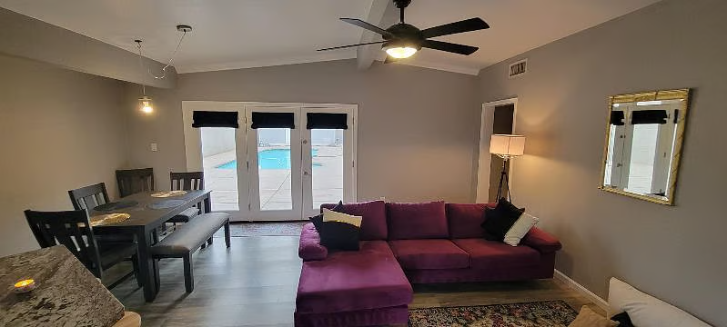 Furnished Phoenix home living room with sectional sofa and pool view