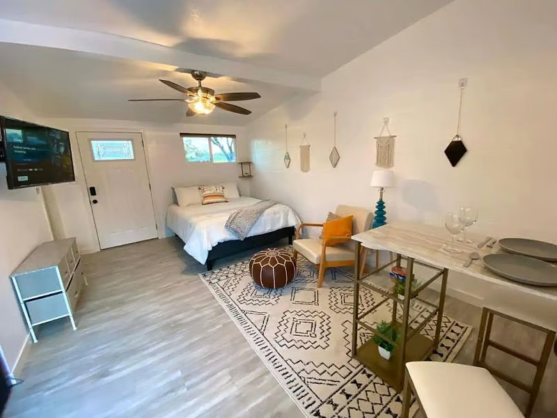 Bright studio with bed, seating area and dining nook
